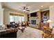 Cozy living room with stone fireplace, built-in shelving, and natural light from large windows at 5284 Vernon Springs Nw Trl, Sandy Springs, GA 30327