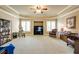 Well-lit living room with tray ceiling, neutral paint, plantation shutters, and a comfortable sitting area at 5284 Vernon Springs Nw Trl, Sandy Springs, GA 30327