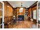 Elegant home office with wood paneled walls, fireplace, built-in bookshelves, and hardwood flooring at 5284 Vernon Springs Nw Trl, Sandy Springs, GA 30327