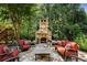 Outdoor stone fireplace, great for relaxation or socializing in a lush backyard at 5284 Vernon Springs Nw Trl, Sandy Springs, GA 30327