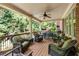 Open-air porch includes ceiling fan, seating and a calming view of the surrounding nature at 5284 Vernon Springs Nw Trl, Sandy Springs, GA 30327