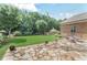 Spacious backyard with a lush lawn, shade trees, and a charming stone patio, perfect for relaxation at 6054 Brookhaven Cir, Duluth, GA 30097