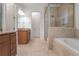 Elegant bathroom with double vanity, soaking tub, separate shower, and stylish tile at 6054 Brookhaven Cir, Duluth, GA 30097