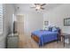 Comfortable bedroom featuring soft carpet, a ceiling fan, and a door leading to a walk-in closet at 6054 Brookhaven Cir, Duluth, GA 30097