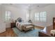 Bright bedroom with hardwood floors, white shutters, and tray ceiling, creating a peaceful retreat at 6054 Brookhaven Cir, Duluth, GA 30097
