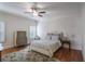 Comfortable bedroom with hardwood floors, ceiling fan, and neutral decor provides a serene space at 6054 Brookhaven Cir, Duluth, GA 30097