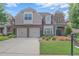 Charming two-story home featuring a brick facade, attached two car garage and manicured lawn at 6054 Brookhaven Cir, Duluth, GA 30097