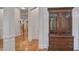 Hallway with hardwood floors and white walls leads to staircase and living area at 6054 Brookhaven Cir, Duluth, GA 30097