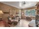 Comfortable living room with ample sunlight, tile flooring, and detailed stone fireplace at 6054 Brookhaven Cir, Duluth, GA 30097