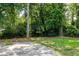 Large backyard featuring mature trees and a concrete slab patio at 1170 Westmont Sw Rd, Atlanta, GA 30311