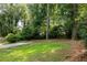 Spacious backyard with lush lawn, mature trees, and ample privacy at 1170 Westmont Sw Rd, Atlanta, GA 30311