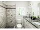 Bright bathroom with a stand-up shower, white vanity, and a large mirror at 1170 Westmont Sw Rd, Atlanta, GA 30311