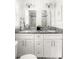 Bright bathroom features a double vanity, granite countertop, and modern fixtures at 1170 Westmont Sw Rd, Atlanta, GA 30311