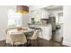 Open-concept dining area with modern lighting and seating near the kitchen at 1170 Westmont Sw Rd, Atlanta, GA 30311