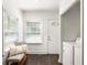 Bright entryway with bench seating, a front door, and a laundry closet at 1170 Westmont Sw Rd, Atlanta, GA 30311