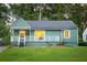 Charming bungalow-style home with covered porch, green lawn, and mature trees at 1170 Westmont Sw Rd, Atlanta, GA 30311