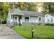 Inviting home with a covered porch, green siding, and a well-kept lawn at 1170 Westmont Sw Rd, Atlanta, GA 30311