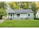Charming single-story home with a quaint front porch and lush green lawn at 1170 Westmont Sw Rd, Atlanta, GA 30311
