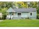 Single-story home with a front porch, a well-maintained lawn, and mature trees at 1170 Westmont Sw Rd, Atlanta, GA 30311