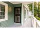 Covered front porch features a secure door with intricate metalwork and white railings at 1170 Westmont Sw Rd, Atlanta, GA 30311