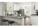 Modern kitchen with bar seating, granite countertops, and stainless steel appliances at 1170 Westmont Sw Rd, Atlanta, GA 30311