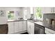 Modern kitchen with white cabinets, stainless appliances, and granite counters at 1170 Westmont Sw Rd, Atlanta, GA 30311