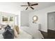 Bright main bedroom featuring neutral decor, ceiling fan, and dark hardwood floors at 1170 Westmont Sw Rd, Atlanta, GA 30311