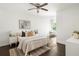 Bright main bedroom with modern decor, plush bedding and a ceiling fan at 1170 Westmont Sw Rd, Atlanta, GA 30311