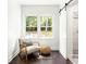 Bright sitting area with a window, neutral chair, and a sliding barn door at 1170 Westmont Sw Rd, Atlanta, GA 30311
