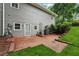Backyard view featuring a small patio with lush green lawn and shrubs at 2655 Nesbit Trl, Alpharetta, GA 30022