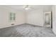 Light-filled bedroom featuring a large window with views and neutral carpeting at 2655 Nesbit Trl, Alpharetta, GA 30022