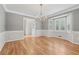 Elegant dining room with a decorative chandelier, bay window, and hardwood floors at 2655 Nesbit Trl, Alpharetta, GA 30022