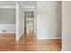 Hallway with hardwood floors connecting rooms, neutral paint, and natural light at 2655 Nesbit Trl, Alpharetta, GA 30022