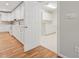Kitchen and Laundry area featuring white cabinetry and hardwood floors at 2655 Nesbit Trl, Alpharetta, GA 30022