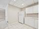 A well-lit, secondary kitchen with white cabinets and tiled flooring, providing extra space for meal prep at 2655 Nesbit Trl, Alpharetta, GA 30022