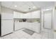 Convenient white kitchen featuring ample cabinet and countertop space, ideal for casual dining at 2655 Nesbit Trl, Alpharetta, GA 30022