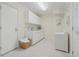 Laundry room with white cabinets, a sink, and a washing machine at 2655 Nesbit Trl, Alpharetta, GA 30022