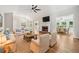 Bright living room with fireplace, ceiling fan, and open access to the dining area at 2655 Nesbit Trl, Alpharetta, GA 30022
