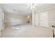 Spacious living room featuring neutral paint, carpet, ceiling fans, and easy access to upper level at 2655 Nesbit Trl, Alpharetta, GA 30022
