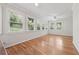 Well-lit sunroom features hardwood floors and large windows at 2655 Nesbit Trl, Alpharetta, GA 30022