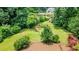 A lush backyard features mature trees, green grass, bushes, landscaping, and a playset at 3854 Ridgewood Se Dr, Smyrna, GA 30080