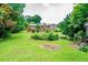A spacious backyard boasts green grass, mature trees, garden beds, and a small storage building at 3854 Ridgewood Se Dr, Smyrna, GA 30080