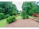 Picturesque backyard featuring mature trees, a playground, and a well-manicured lawn at 3854 Ridgewood Se Dr, Smyrna, GA 30080