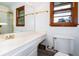 Bathroom featuring a vanity, toilet, window, and framed mirror at 3854 Ridgewood Se Dr, Smyrna, GA 30080