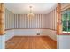 Bright dining room featuring gleaming hardwood floors, elegant wallpaper, and ample natural light at 3854 Ridgewood Se Dr, Smyrna, GA 30080