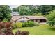 Exterior view of charming brick home with a covered carport and a well-maintained lawn at 3854 Ridgewood Se Dr, Smyrna, GA 30080