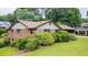 An exterior view of a well-maintained brick home with a well-manicured lawn and mature landscaping at 3854 Ridgewood Se Dr, Smyrna, GA 30080