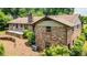 Brick home showcasing a large backyard with a wooden retaining wall and deck at 3854 Ridgewood Se Dr, Smyrna, GA 30080