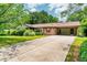 Charming one-story brick home featuring a covered carport, well-maintained lawn, and mature landscaping at 3854 Ridgewood Se Dr, Smyrna, GA 30080