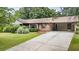 Charming brick home with a covered carport, well-maintained lawn, and mature landscaping at 3854 Ridgewood Se Dr, Smyrna, GA 30080